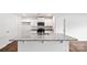 Stylish kitchen island featuring granite countertops, a sink, and modern white cabinets, complemented by stainless steel appliances at 2656 Goose Fair Rd # 126, Maiden, NC 28650