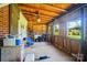 Back porch featuring rustic wood paneling, windows with backyard view, and concrete flooring at 2722 Catawba Church Rd, Rock Hill, SC 29730