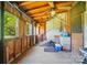 Enclosed back porch showcasing rustic wood paneling and ample natural light at 2722 Catawba Church Rd, Rock Hill, SC 29730
