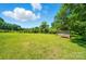 Spacious backyard featuring lush green grass and a storage shed in the distance at 2722 Catawba Church Rd, Rock Hill, SC 29730