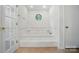 Bathroom with a large step-up tub and a small, unique window at 2722 Catawba Church Rd, Rock Hill, SC 29730