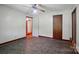 Cozy bedroom featuring a ceiling fan, dark trim, unique flooring and a dark wooden door at 2722 Catawba Church Rd, Rock Hill, SC 29730