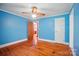 Blue bedroom featuring wood floors, a ceiling fan, and doorway to an attached room at 2722 Catawba Church Rd, Rock Hill, SC 29730