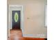 Entryway with hardwood floors leading to an oval glass paneled front door and white walls at 2722 Catawba Church Rd, Rock Hill, SC 29730