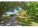 Quaint single-story home with a brick chimney and a covered parking area surrounded by lush greenery at 2722 Catawba Church Rd, Rock Hill, SC 29730