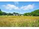 Expansive front yard with a charming house in the background, under a partly cloudy blue sky at 2722 Catawba Church Rd, Rock Hill, SC 29730