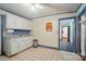 Efficient kitchen with white cabinets and vintage flooring, that opens to the adjacent dining room area at 2722 Catawba Church Rd, Rock Hill, SC 29730