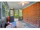 Enclosed sunroom featuring a brick wall, ceiling fan, and an open doorway leading to the outside at 2722 Catawba Church Rd, Rock Hill, SC 29730