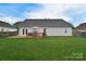 Beautiful backyard with a wooden deck, a manicured lawn, and mature trees offering shade and privacy at 2836 Rosemeade Dr, Monroe, NC 28110