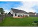 Well-maintained backyard with a green lawn, wooden fence, and a patio area ideal for relaxing outdoors at 2836 Rosemeade Dr, Monroe, NC 28110