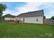 Large backyard showing the outdoor deck with seating, ample green space, and a well-kept lawn at 2836 Rosemeade Dr, Monroe, NC 28110