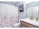 Inviting bathroom features a sink with a cabinet and shower with a floral curtain at 2836 Rosemeade Dr, Monroe, NC 28110