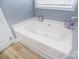 Bright bathroom features a large soaking tub, perfect for relaxation and comfort at 2836 Rosemeade Dr, Monroe, NC 28110