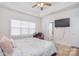 A well-lit bedroom with a desk and TV provides a relaxing atmosphere at 2836 Rosemeade Dr, Monroe, NC 28110