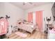 Bright bedroom with pink accents features a ceiling fan and natural light at 2836 Rosemeade Dr, Monroe, NC 28110