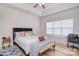 Comfortable bedroom features a modern bed with a ceiling fan and natural light at 2836 Rosemeade Dr, Monroe, NC 28110