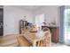 Cozy dining area featuring a wooden table, bench seating, and natural light at 2836 Rosemeade Dr, Monroe, NC 28110