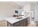 Bright, open kitchen design with a large quartz countertop island and modern finishes at 2836 Rosemeade Dr, Monroe, NC 28110
