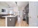 Open concept kitchen showcases a quartz countertop island and stainless steel faucet at 2836 Rosemeade Dr, Monroe, NC 28110