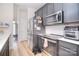 Updated kitchen boasts stainless steel appliances, sleek gray cabinetry, and subway tile backsplash at 2836 Rosemeade Dr, Monroe, NC 28110