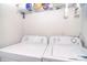 Functional laundry room equipped with modern, white washing machine and dryer at 2836 Rosemeade Dr, Monroe, NC 28110