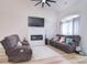 Comfortable living room with hardwood floors, a fireplace, comfortable seating, and natural lighting at 2836 Rosemeade Dr, Monroe, NC 28110