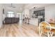 Open-concept living area with hardwood floors, a kitchen island with barstools, and ample seating at 2836 Rosemeade Dr, Monroe, NC 28110
