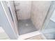 Modern tiled shower boasts a decorative floor with sleek fixtures and glass door at 2836 Rosemeade Dr, Monroe, NC 28110