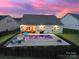 A stunning backyard oasis featuring a sparkling pool, an outdoor seating area, and vibrant landscaping at 3255 Split Rail Ln, Lancaster, SC 29720