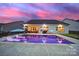 An eye-catching view of the backyard with a glittering pool and patio underneath a colorful sky at 3255 Split Rail Ln, Lancaster, SC 29720