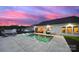 Enjoy the evening by the pool in this backyard oasis with patio and manicured yard at 3255 Split Rail Ln, Lancaster, SC 29720