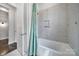 Bright bathroom showcasing tub with tiled wall and open doorway at 3255 Split Rail Ln, Lancaster, SC 29720
