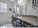 Bathroom featuring granite countertops, modern fixtures, and a large mirror over a dark vanity at 3255 Split Rail Ln, Lancaster, SC 29720