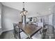 Open dining room leading to the kitchen, featuring a modern chandelier and hardwood floors at 3255 Split Rail Ln, Lancaster, SC 29720