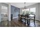 Bright dining room featuring hardwood floors, a modern chandelier, and a large clock on the accent wall at 3255 Split Rail Ln, Lancaster, SC 29720