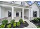 Inviting front porch features decorative pillars and manicured landscaping at 3255 Split Rail Ln, Lancaster, SC 29720