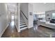 Hallway with hardwood floors, stairs, and view of the living room and kitchen at 3255 Split Rail Ln, Lancaster, SC 29720