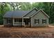 Charming single-story home with a covered porch and black shutters, nestled in a wooded area at 3452 Hands Mill Hwy, York, SC 29745