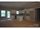 Unfinished kitchen with white cabinets, granite countertops, and a center island; ready for personalization at 3452 Hands Mill Hwy, York, SC 29745