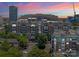 Stunning aerial view of community condos, lush landscaping, and picturesque sunset in the background at 400 N Church St # 422, Charlotte, NC 28202