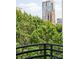 Balcony view of cityscape with building in background surrounded by lush trees at 400 N Church St # 422, Charlotte, NC 28202