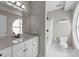 Bright bathroom featuring a white-tiled shower, granite countertop, and modern fixtures at 400 N Church St # 422, Charlotte, NC 28202