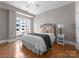 Cozy bedroom featuring natural light from a window and complemented by hardwood floors at 400 N Church St # 422, Charlotte, NC 28202