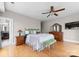 Bright bedroom with a ceiling fan, warm hardwood floors, and ample space for relaxation and personalization at 400 N Church St # 422, Charlotte, NC 28202