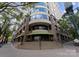 Exterior shot of a stately building with stepped entrance, awnings, and surrounding greenery at 400 N Church St # 422, Charlotte, NC 28202