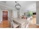 Open dining area with modern chandelier, hardwood flooring, and neutral decor at 400 N Church St # 422, Charlotte, NC 28202