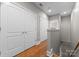 Hallway with hardwood floors, closet space, and neutral paint offers practicality and clean aesthetic at 400 N Church St # 422, Charlotte, NC 28202