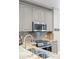 Modern kitchen featuring stainless steel appliances, granite countertops, and stylish gray cabinets at 400 N Church St # 422, Charlotte, NC 28202