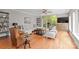 Spacious living area featuring hardwood floors, neutral colors, and access to outdoor balcony at 400 N Church St # 422, Charlotte, NC 28202