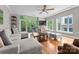 Comfortable living room with large windows, hardwood floors and access to balcony with nature views at 400 N Church St # 422, Charlotte, NC 28202